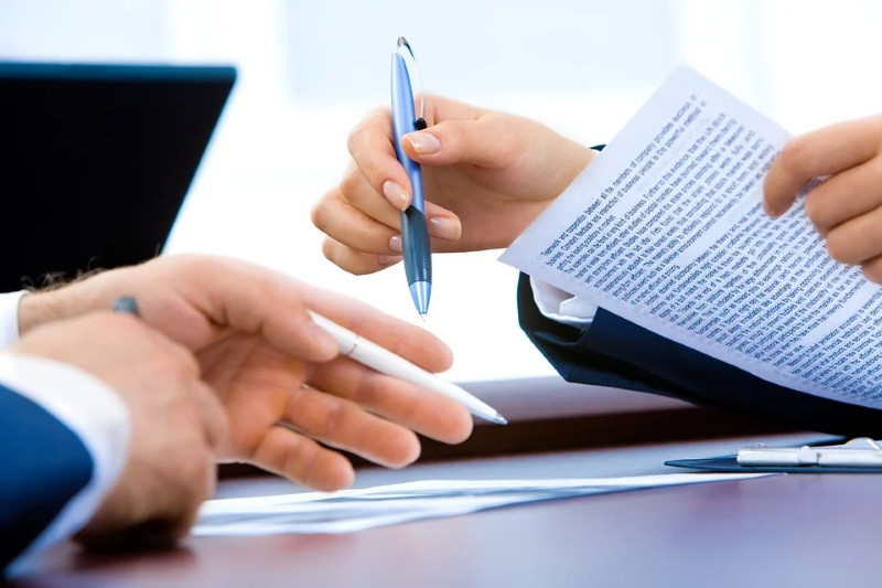 Hands signing documents